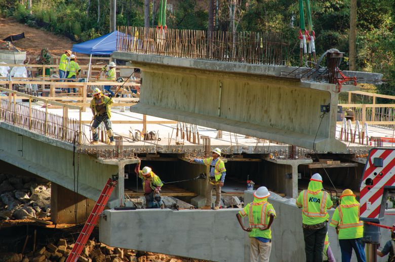 Decked beam unit being erected into final location at end span. Photo: CHA Consulting.